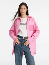 a lady in over-sized pink shirt with white t-shirt and jeans
